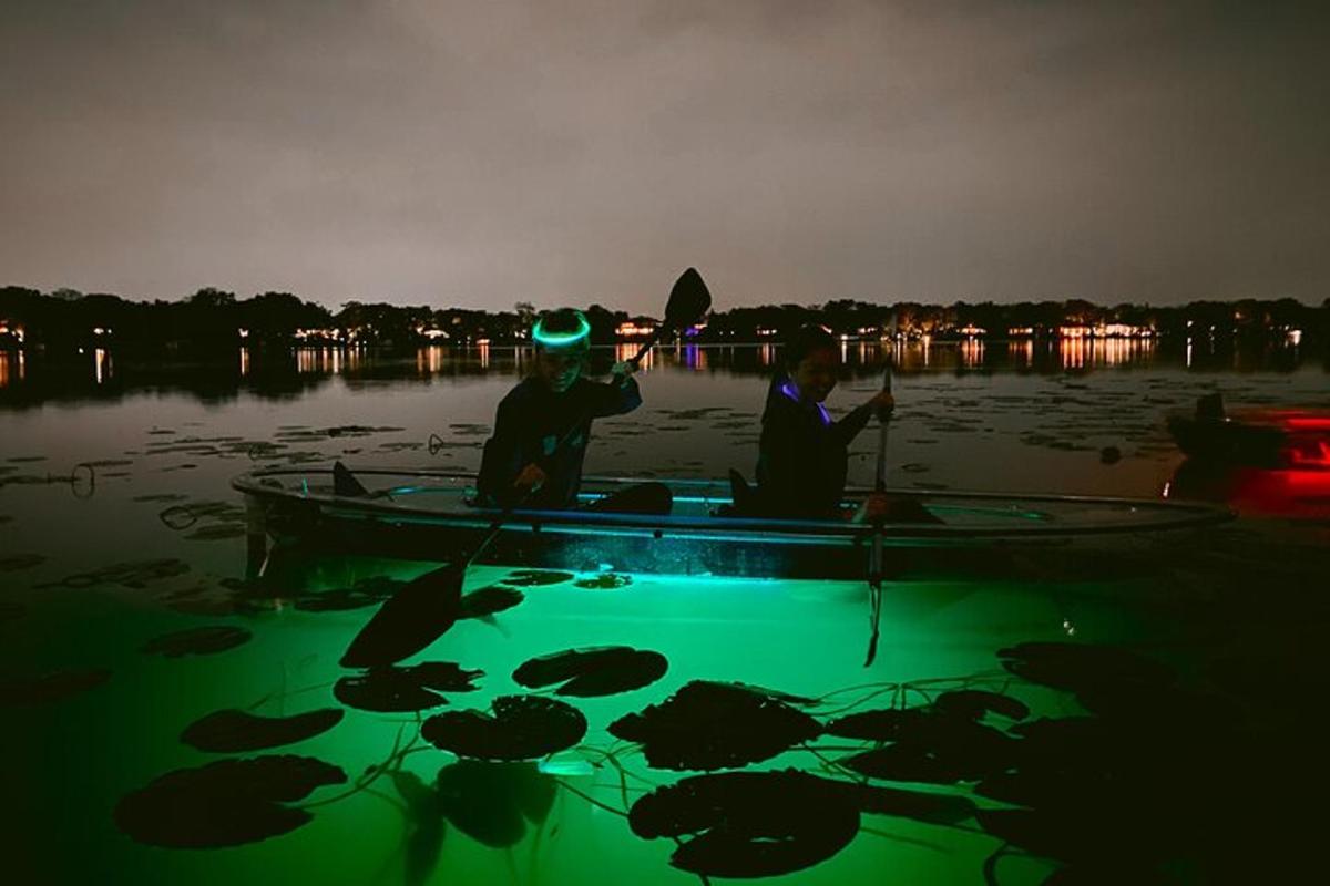 Dos hombres en un bote en el agua por la noche