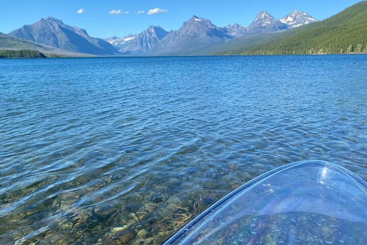 a boat in a large body of water with mountains