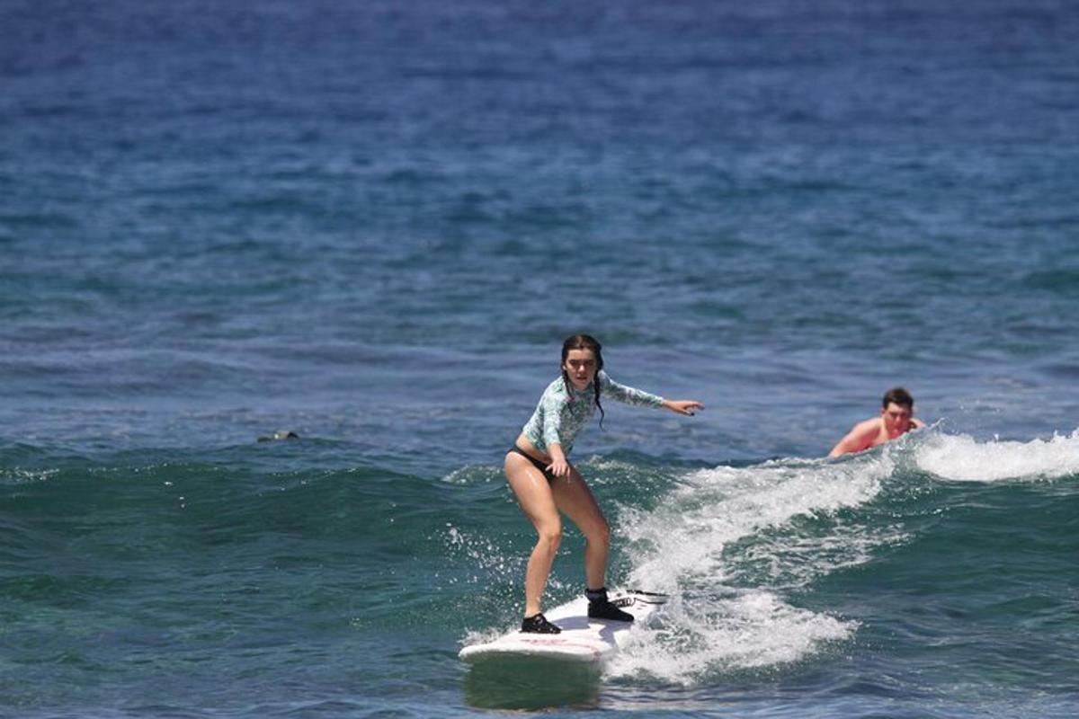 a woman riding a wave on a surfboard in the ocean