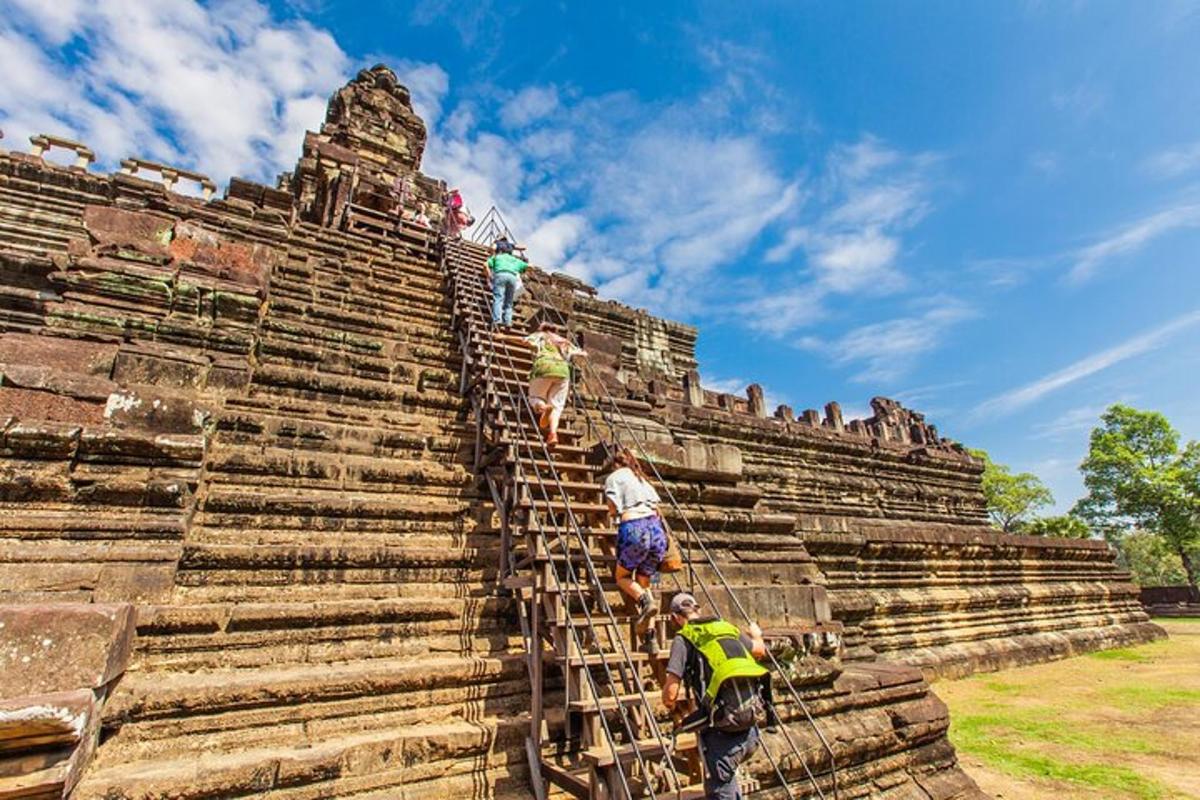 people climbing up the stairs of an ancient temple