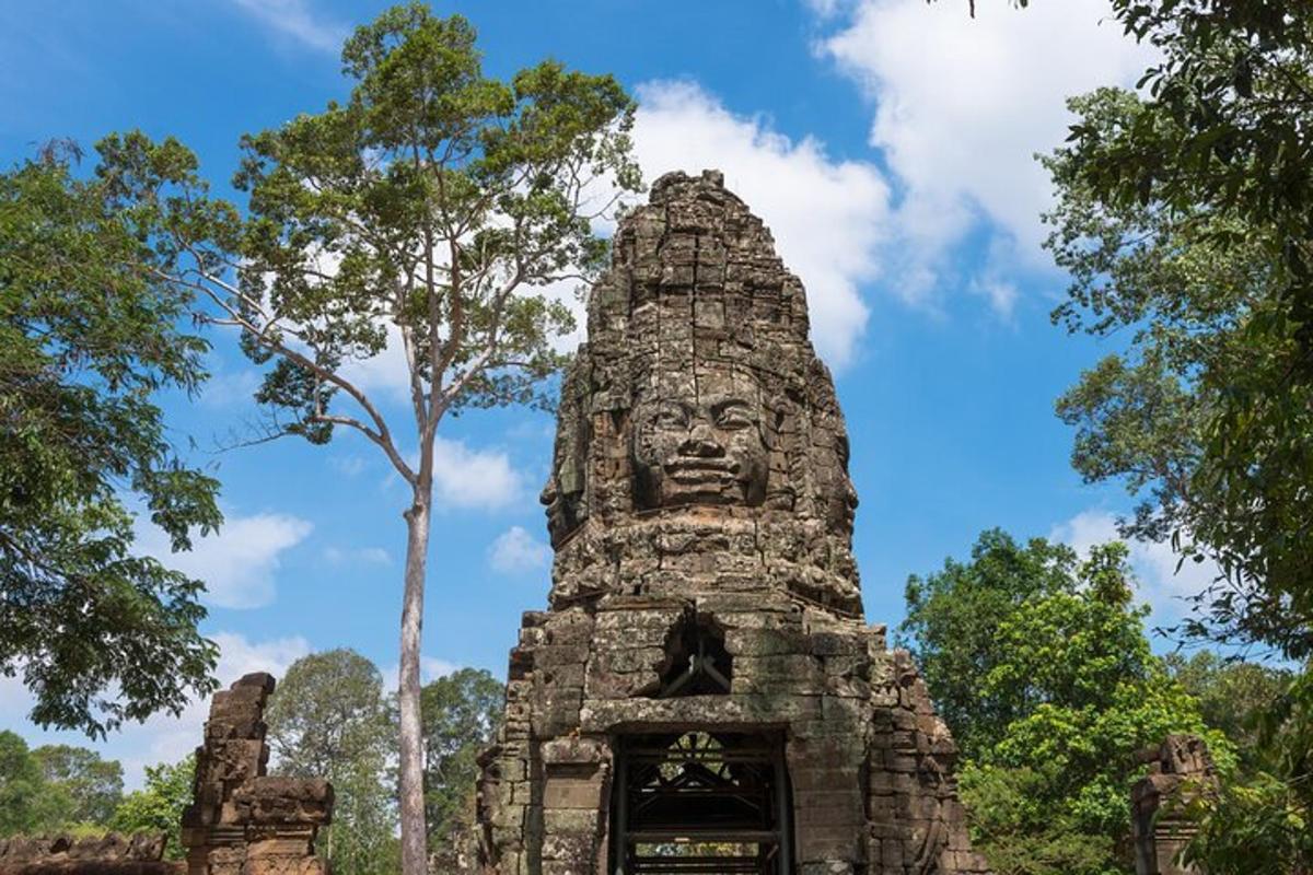 a tall stone building with a face on it