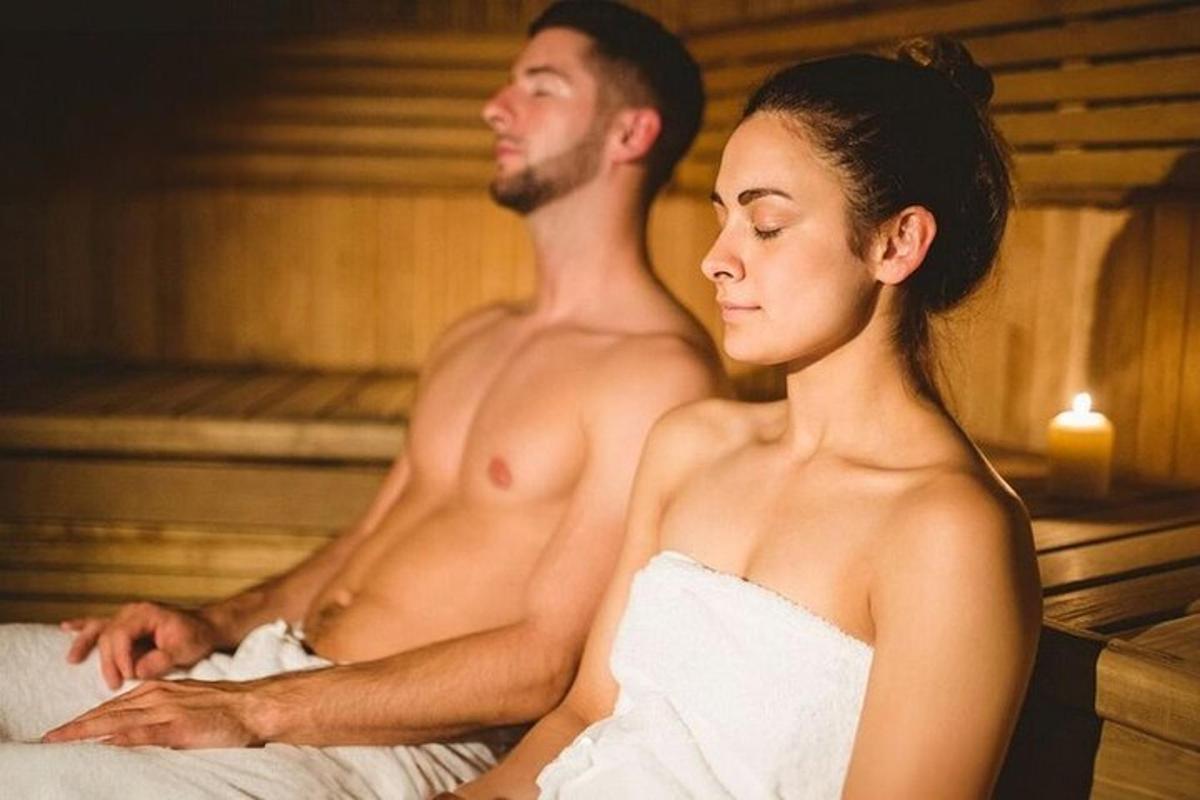 a man and a woman sitting in a sauna