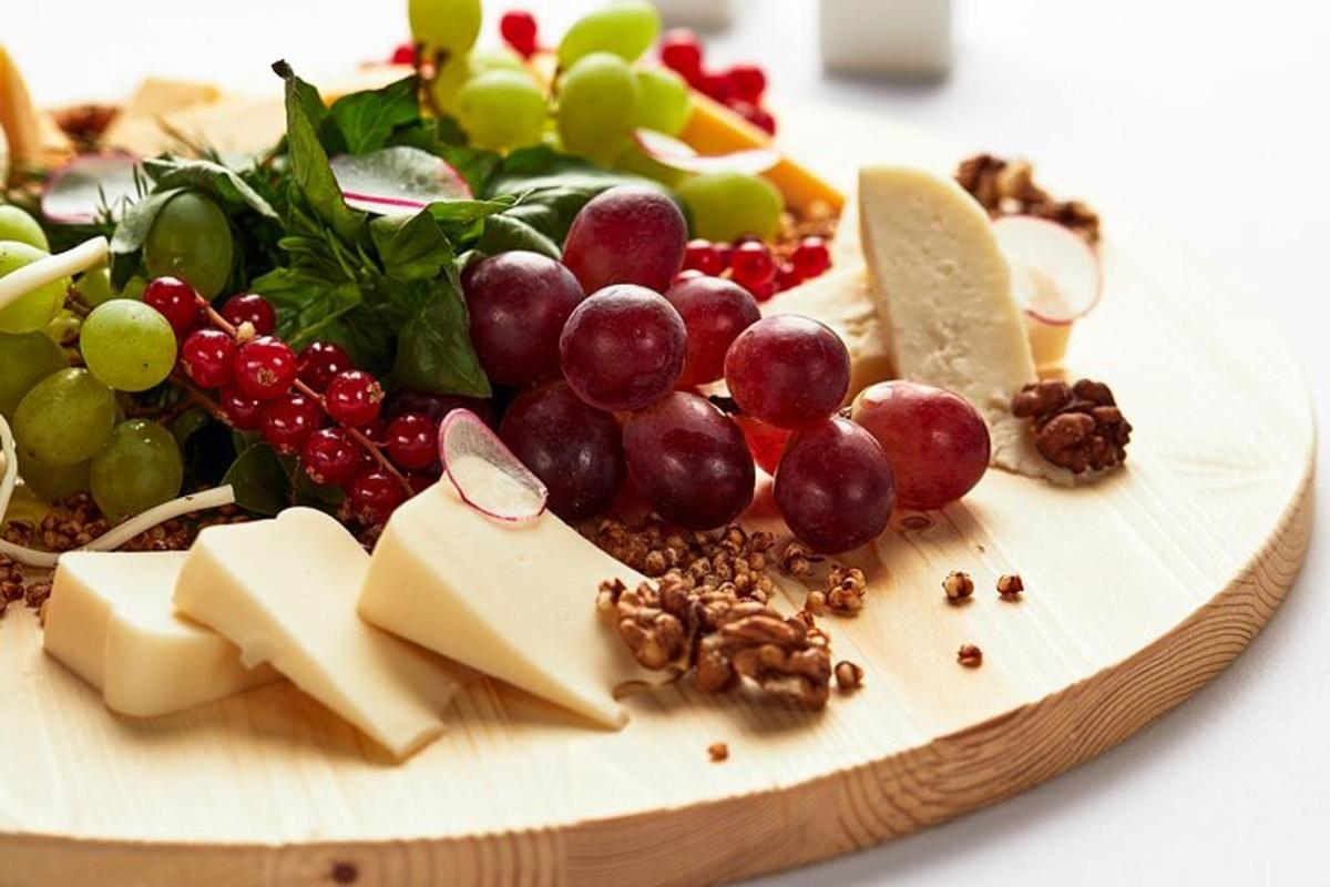 a plate of food with different types of cheese and grapes