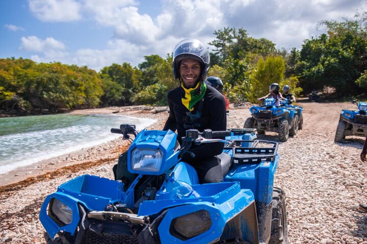 um homem sentado em um quadriciclo azul na praia