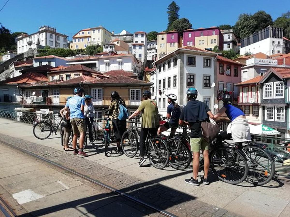 a group of people standing with bikes on a bridge