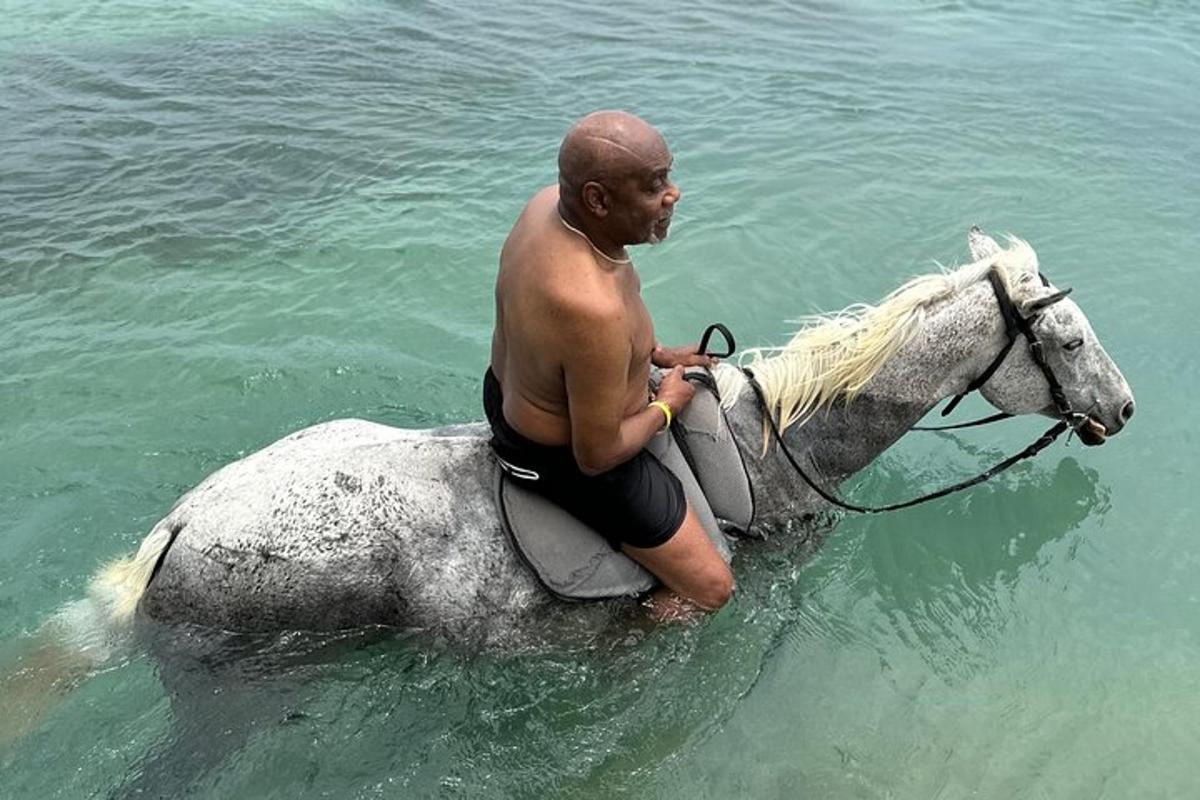 a man riding a horse in the water