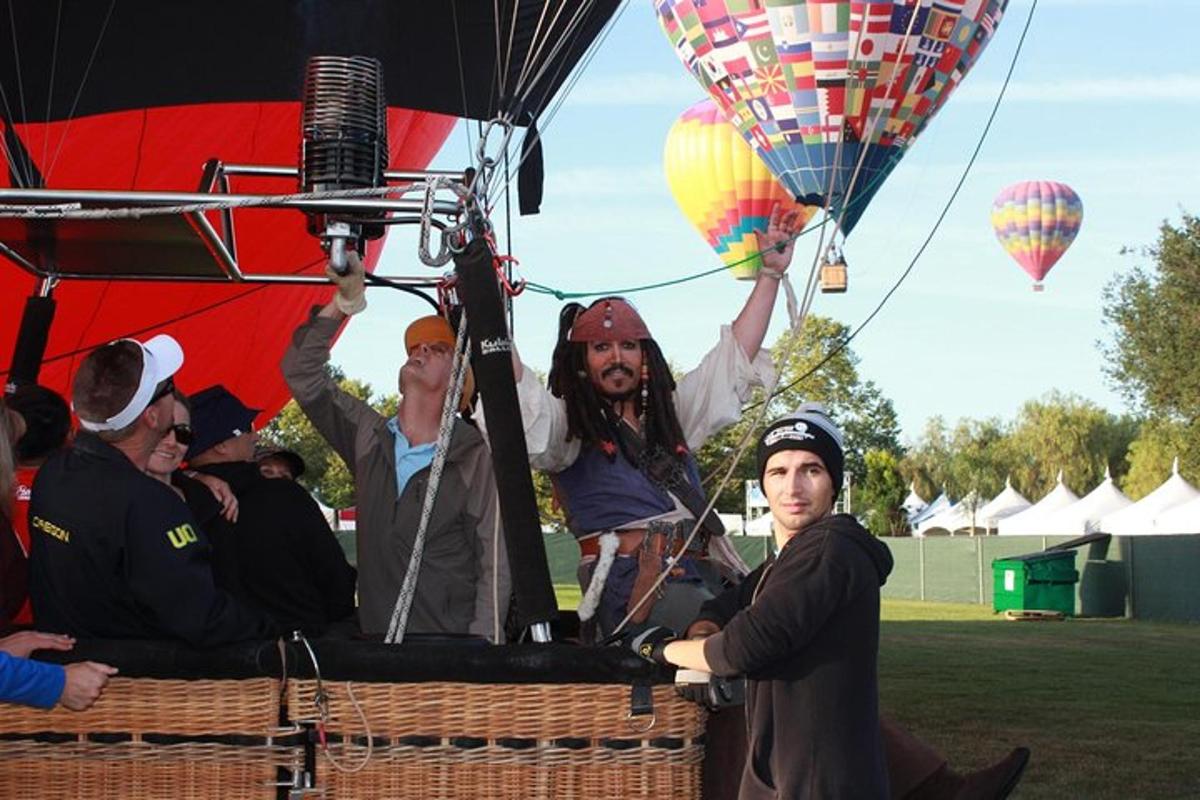 a group of people in a basket with hot air balloons