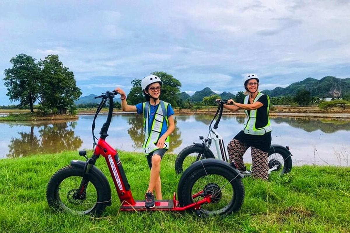 two women are standing next to their bikes