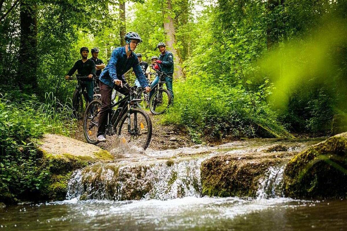 a group of people riding bikes over a waterfall