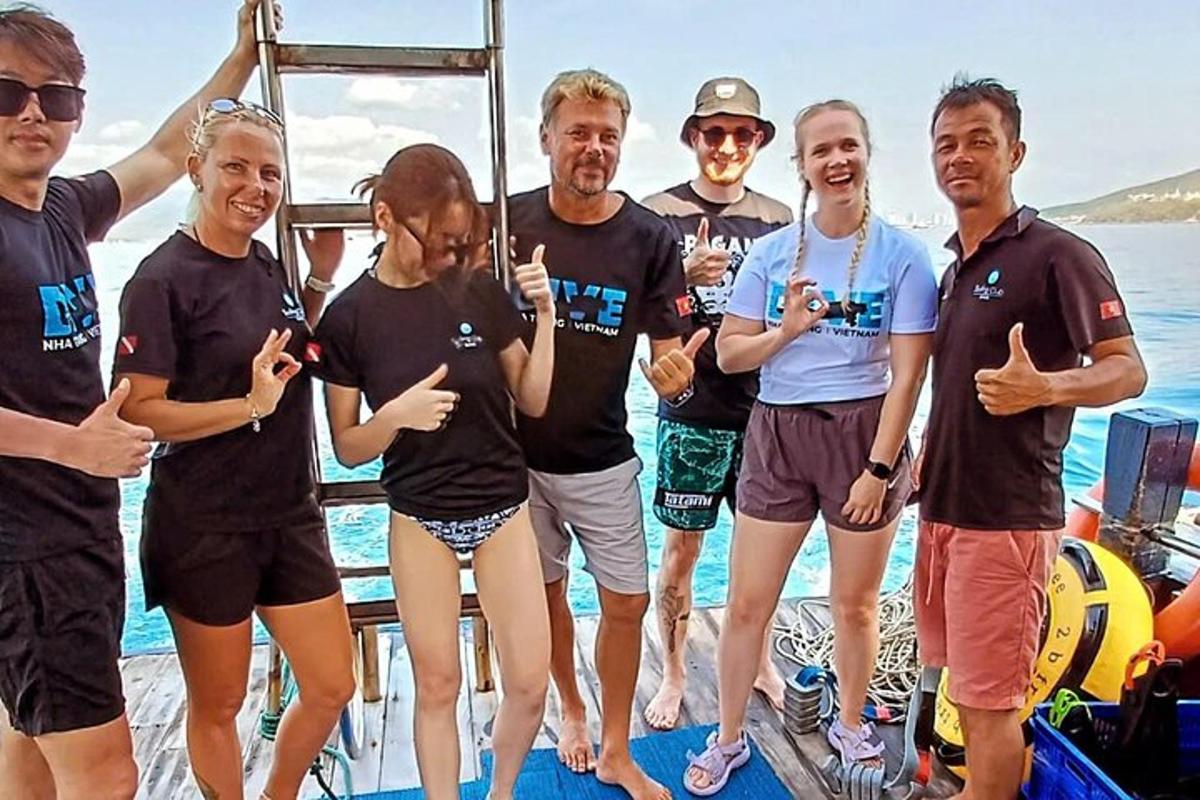 a group of people posing for a picture on a boat