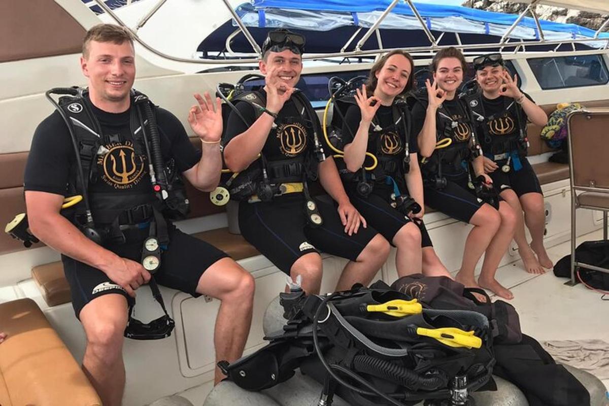 a group of people in scuba gear on a boat