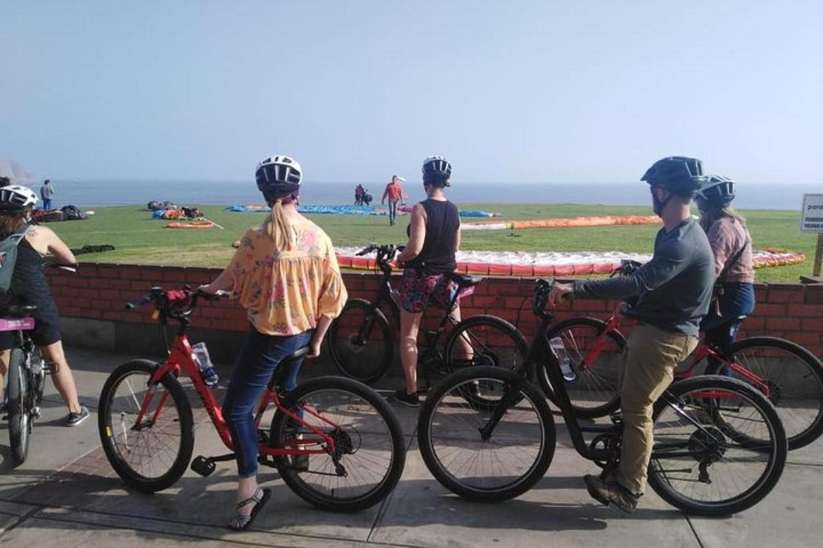 un grup de oameni cu biciclete parcate lângă un zid