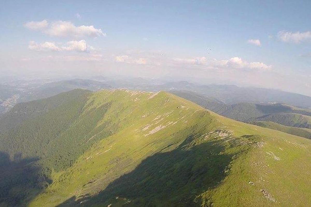 an aerial view of a green mountain