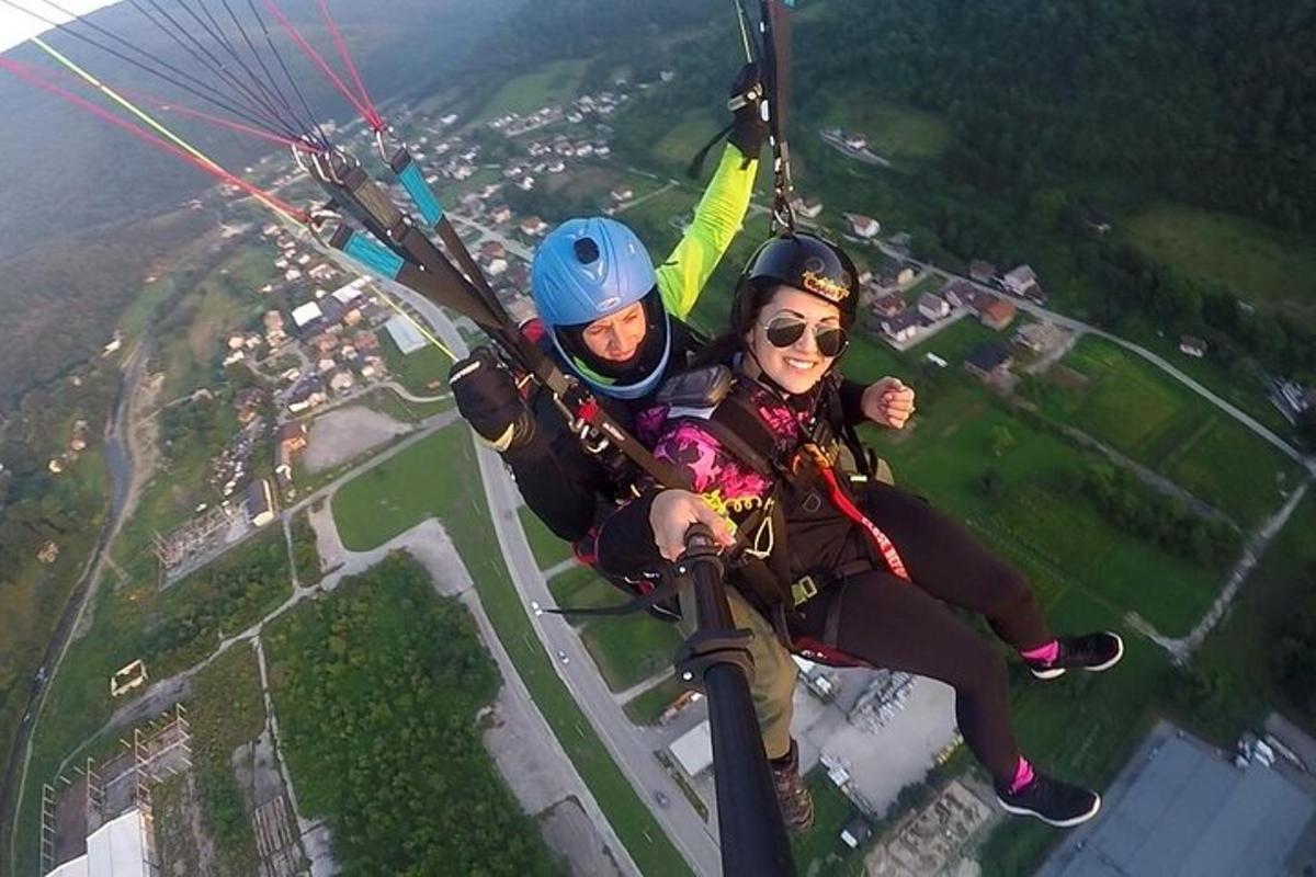 two people are riding on a parachute