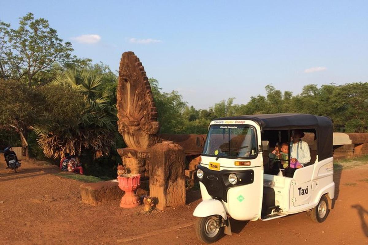 a small golf cart with people riding in it