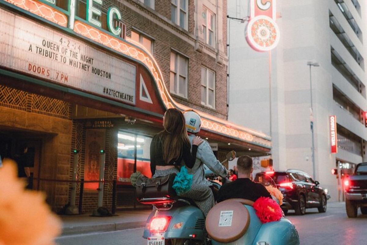 dalawang tao na nakasakay sa scooter sa isang kalye ng lungsod