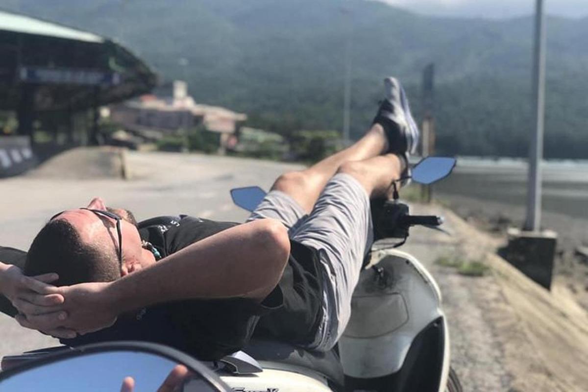 a man laying on a motorcycle on the road