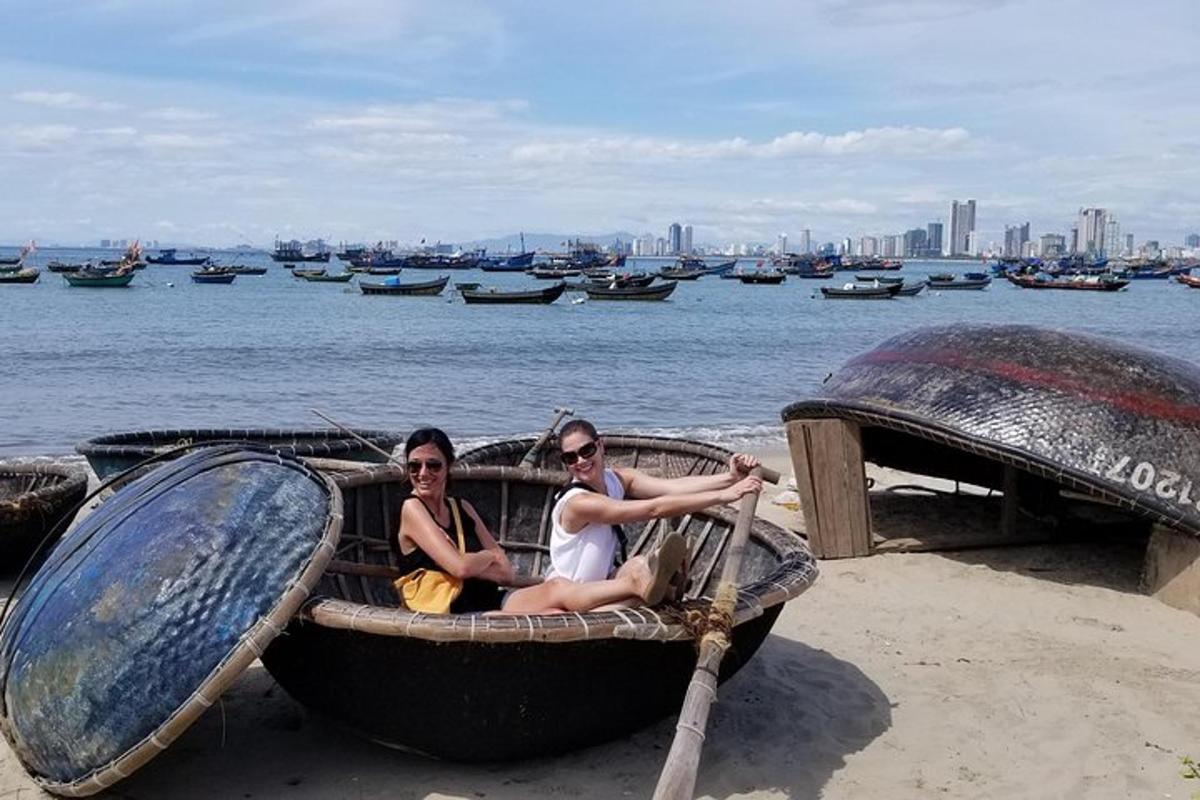 duas pessoas sentadas em um barco na praia