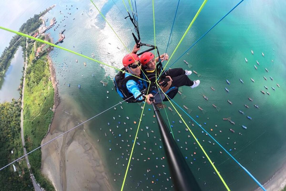 two people are on a zip line over the water