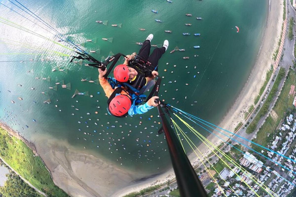 a man is suspended in the air over the water
