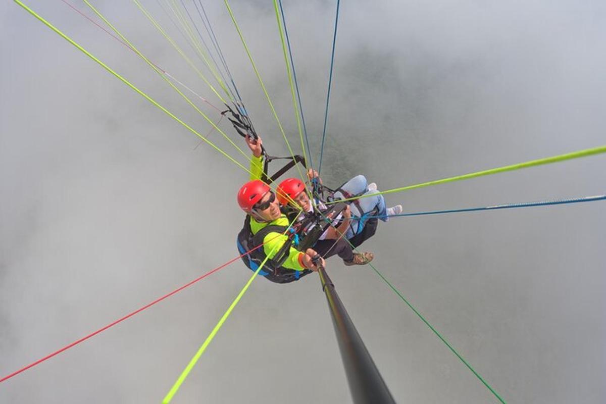 two people are hanging on a rope in a zip line