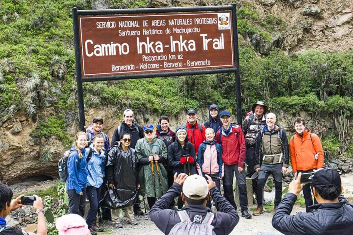 a group of people standing in front of a sign
