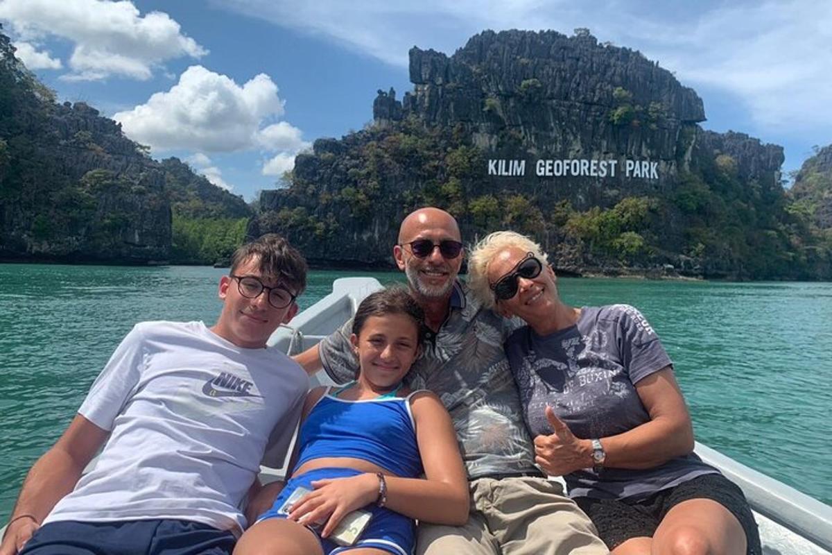 a group of people sitting in a boat on the water