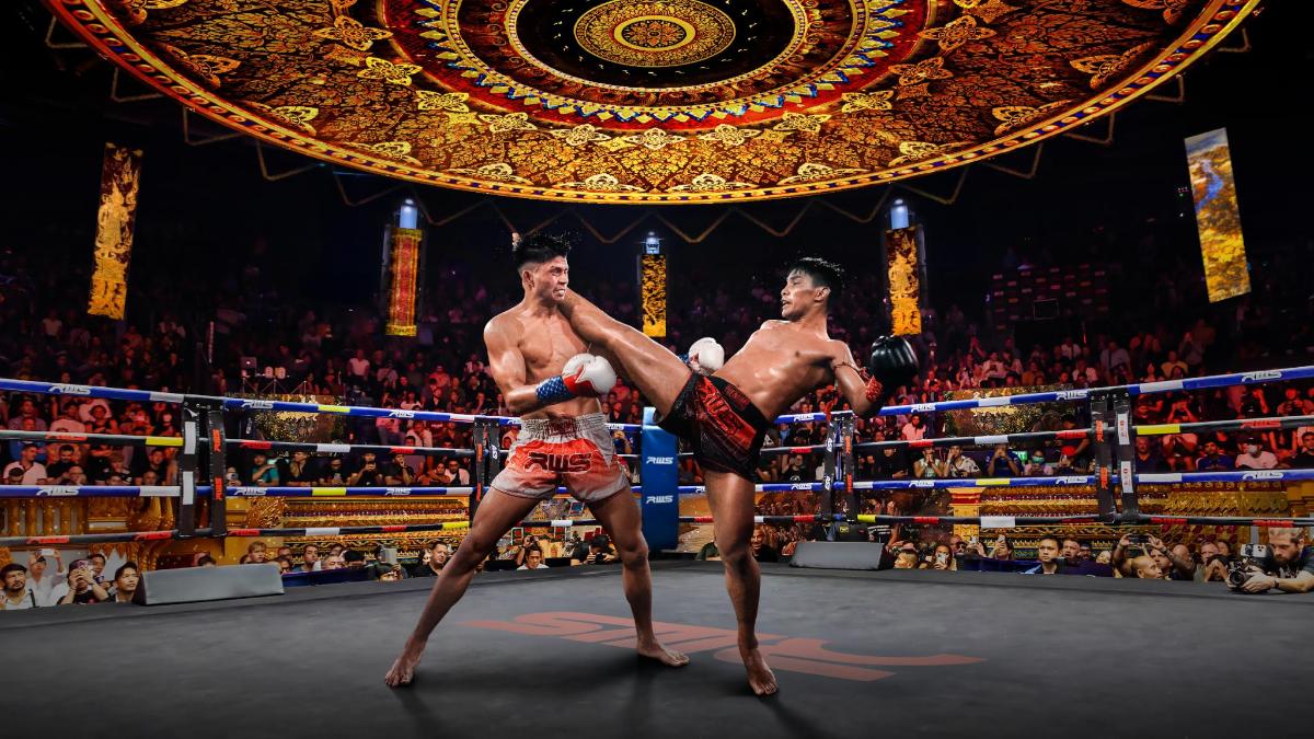 two men in a boxing match in front of a crowd