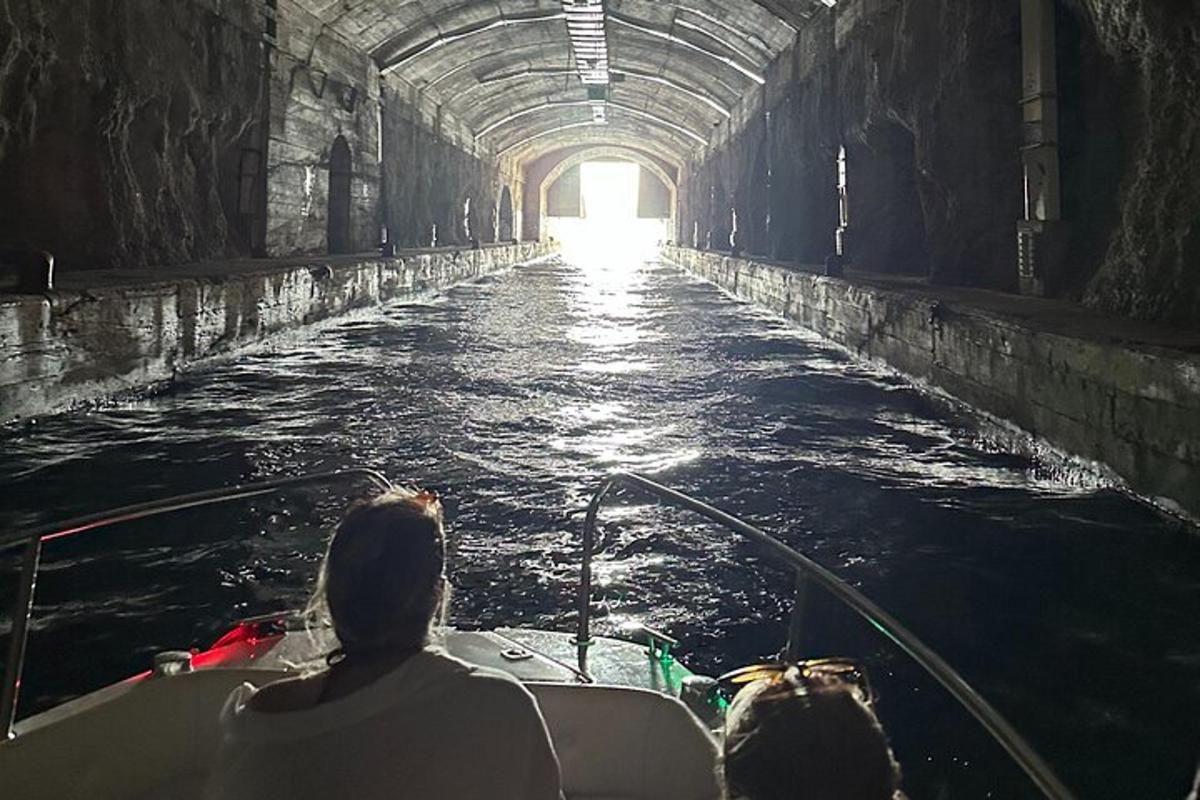 a couple of people riding a boat in a tunnel