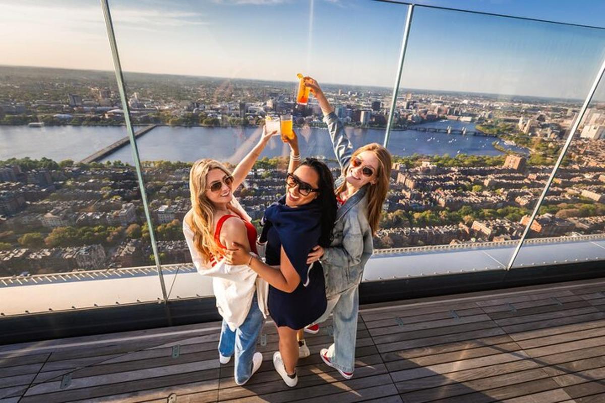 three girls are posing in front of a viewing tower