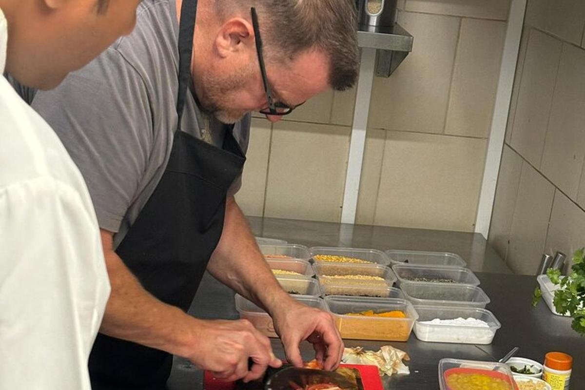 a man standing in a kitchen preparing food