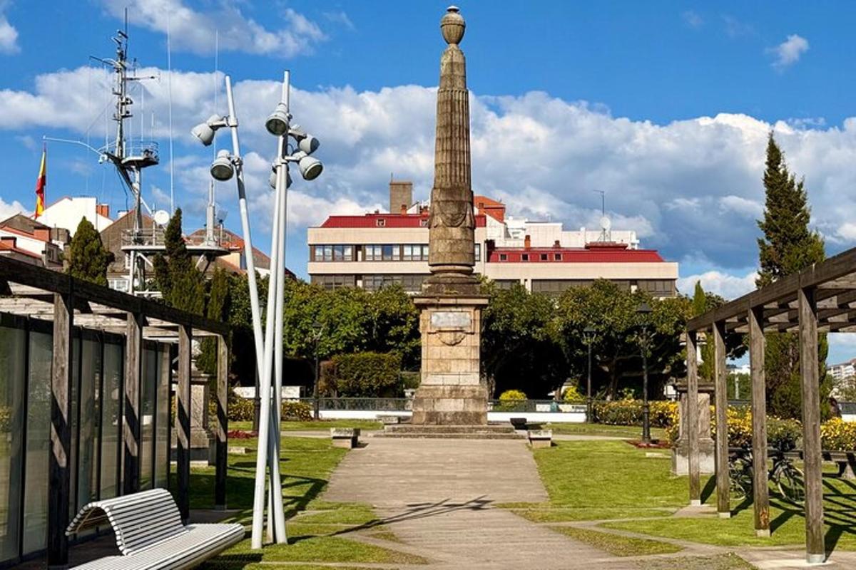 a monument in a park with a building in the background
