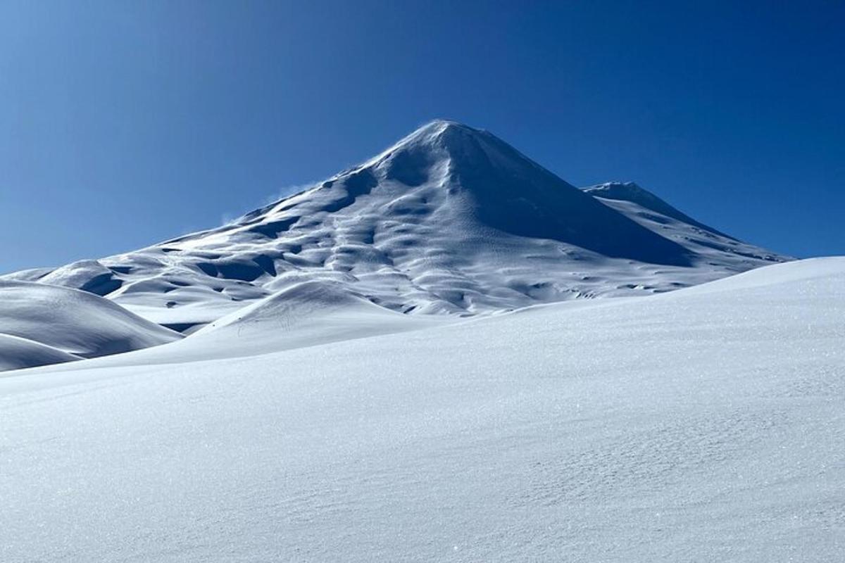 一座白雪皑皑的山峰，前面是一座白雪皑皑的山坡