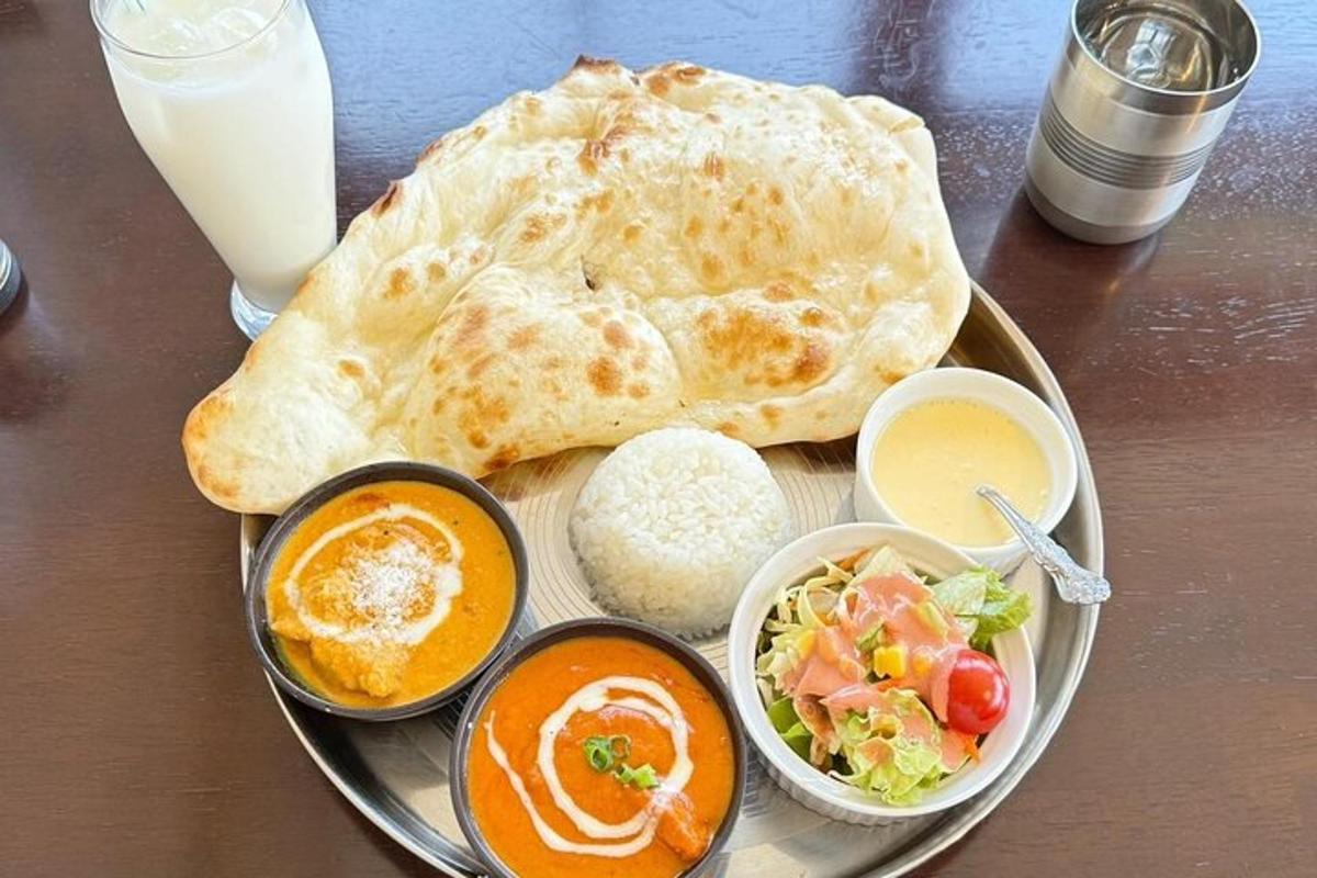 a plate of food with a pita and bowls of food