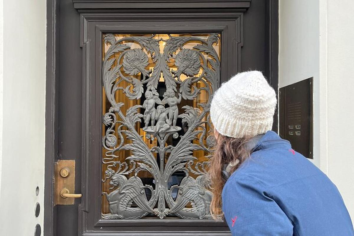 Una mujer está mirando una puerta de metal.
