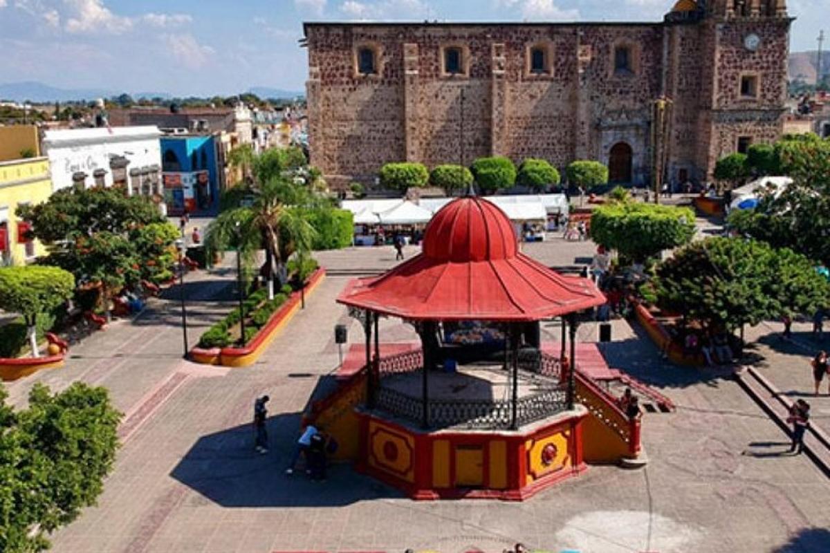 a building with a red roof in a city