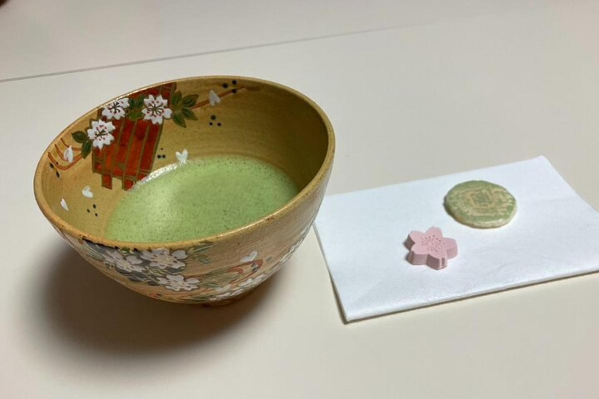 a bowl with green liquid in it next to a card