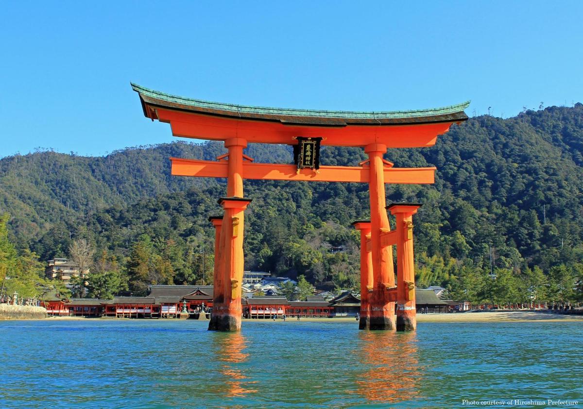an orange torii gate in the middle of the water