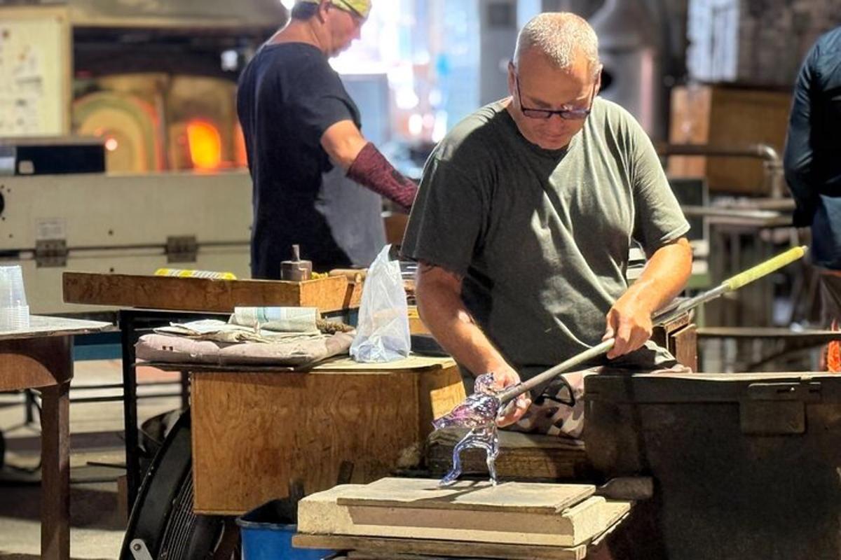 a man ironing a piece of wood on a table