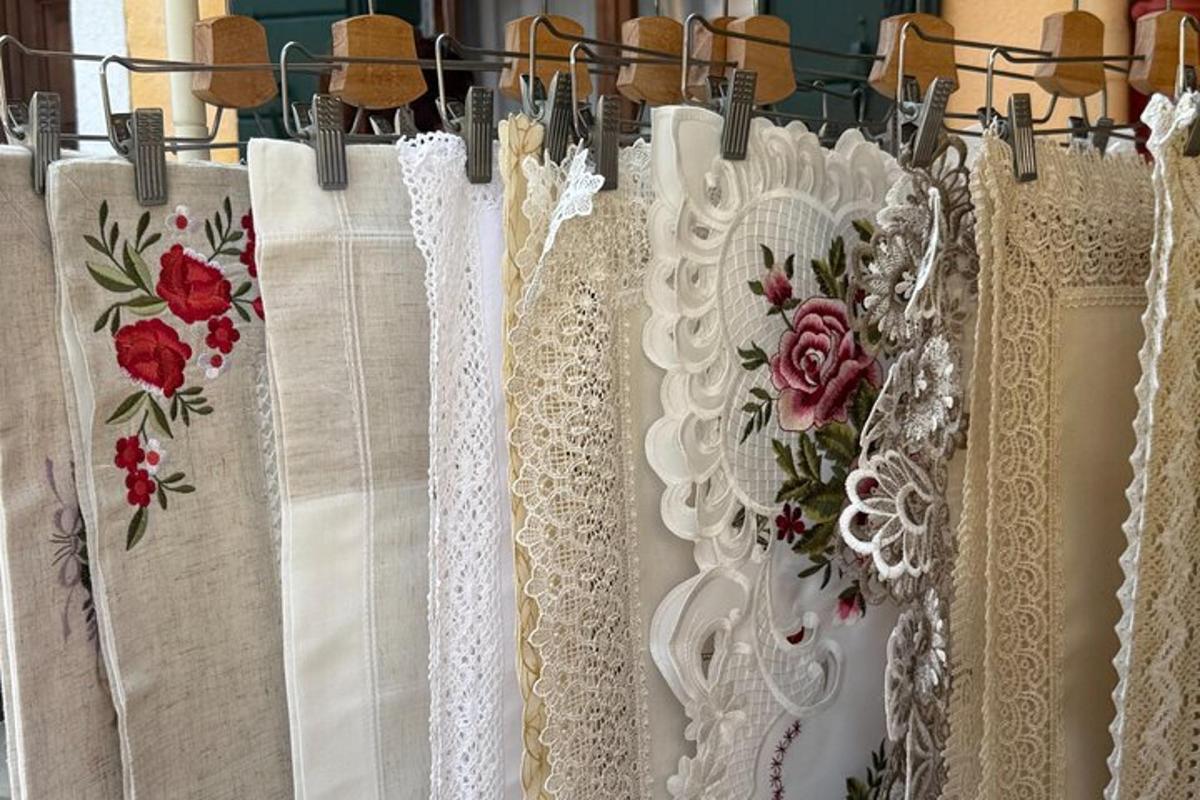 a row of white lace gowns hanging on a rack