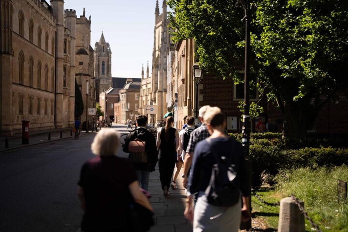 a group of people walking down a city street