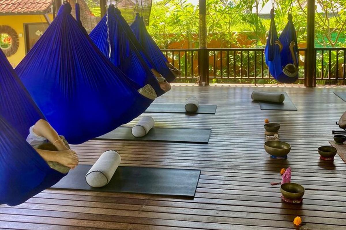 a group of blue hammocks on a deck