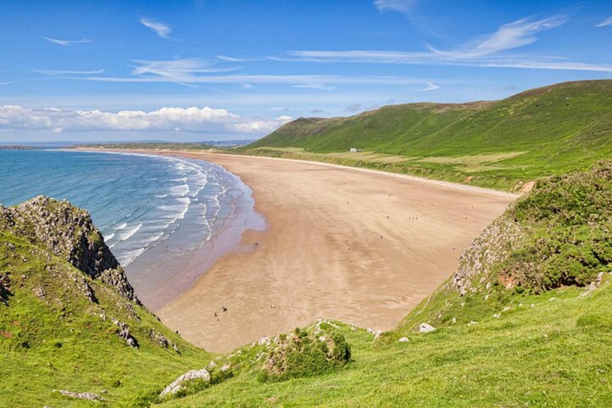 a view of a beach with the ocean and mountains