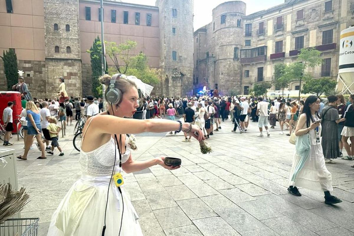 a woman wearing headphones pointing at a crowd of people