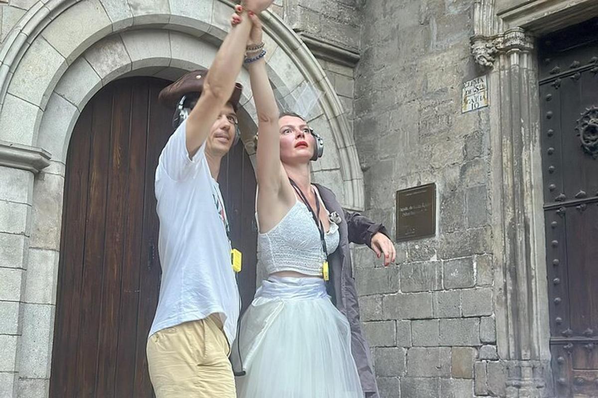 a man and a woman standing in front of a building