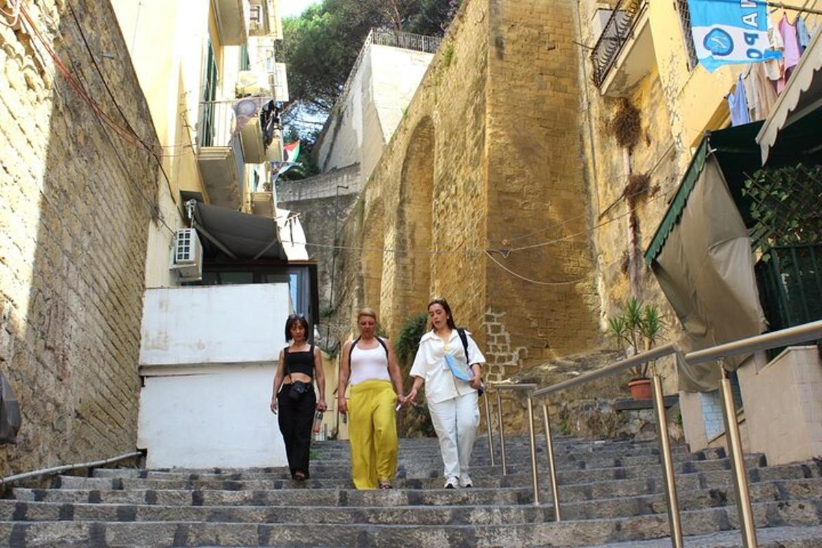 three women walking down stairs in an alley