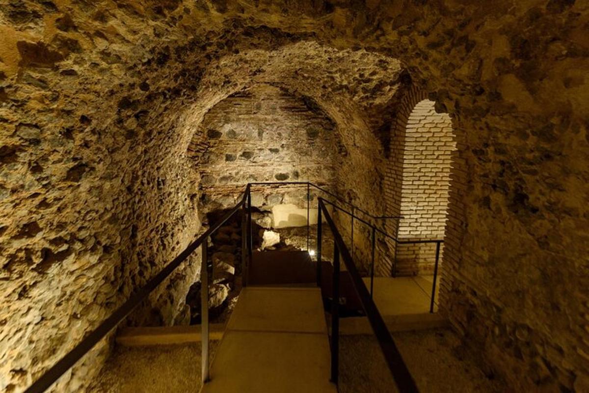a staircase in a cave with a stone wall