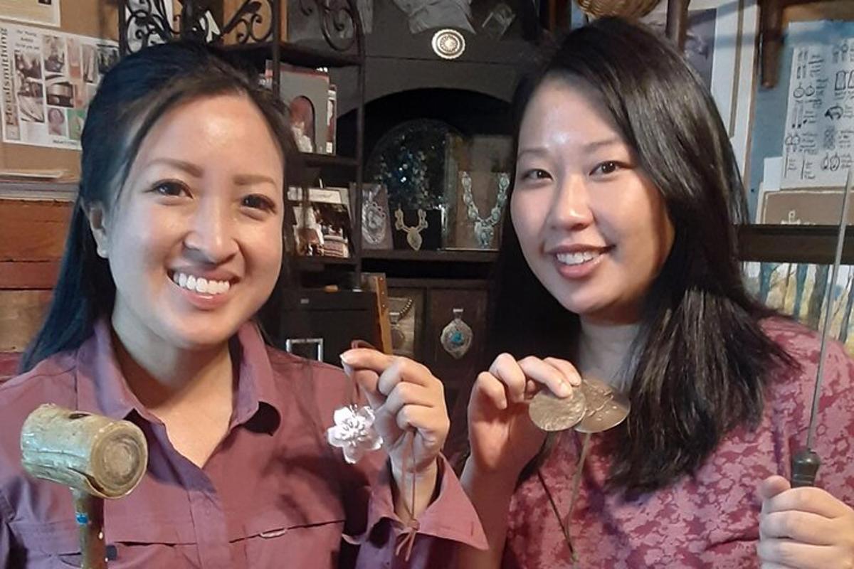 two women are holding up coins in a store