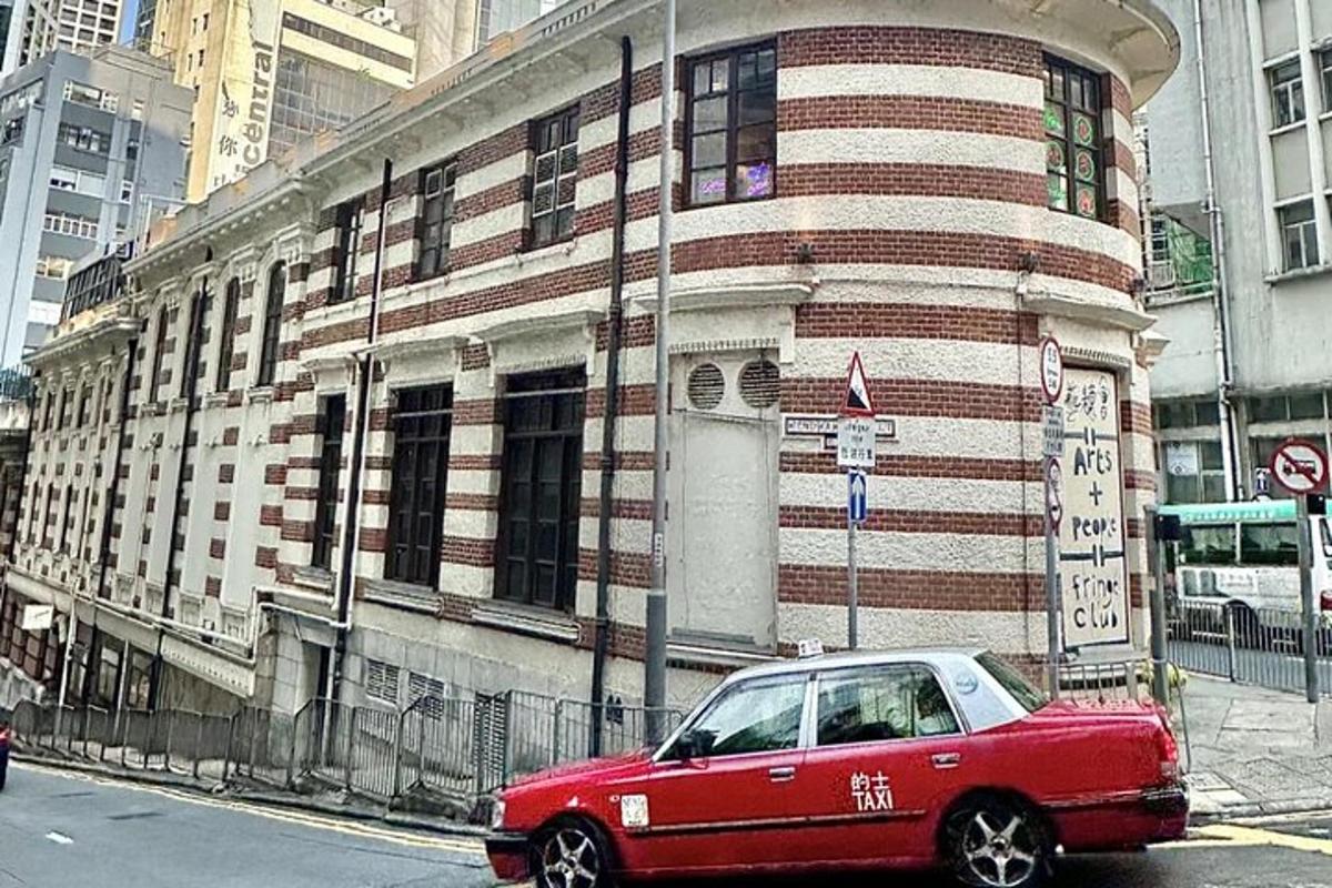 a red car parked in front of a building