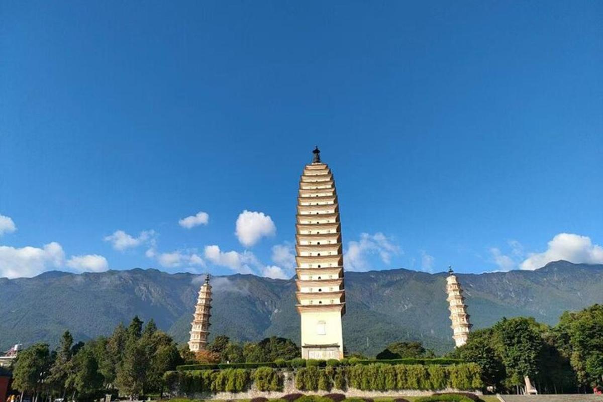 a tall building with two towers in front of a mountain